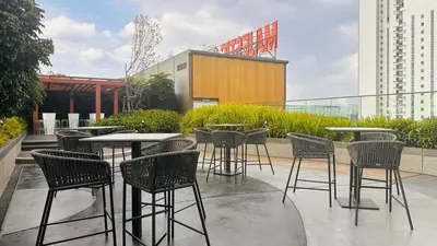 a group of tables and chairs on a patio at Private family apartment 27131BR at Majestic Residence in Kuala Lumpur