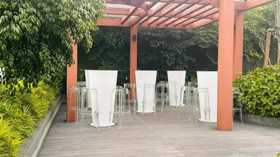 a group of tables and chairs on a patio at Luxury couple suite 23A3A at Majestic Residence in Kuala Lumpur