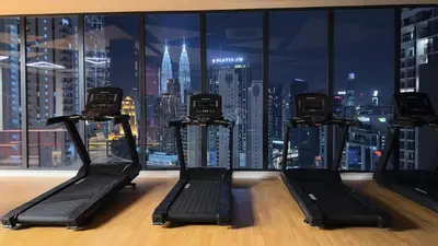 a gym with a view of a city skyline at Luxury couple suite 23A3A at Majestic Residence in Kuala Lumpur