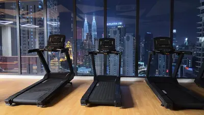 a gym with a view of a city skyline at Luxury studio for couple 267B at KLCC in Kuala Lumpur