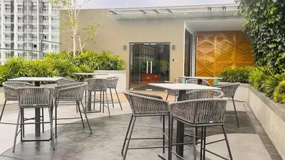 a group of tables and chairs on a patio at Cozy couple suite 23A3B at KLCC in Kuala Lumpur
