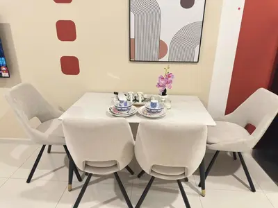 a white dining room table with white chairs and a white table and chairsearcher at Cozy couple suite 23A3B at KLCC in Kuala Lumpur