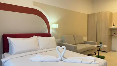 two swans towels on a bed in a hotel room at Cozy suite for couples 291B at KLCC in Kuala Lumpur
