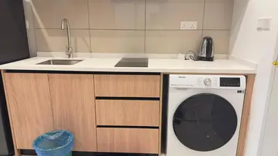 a kitchen with a sink and a washing machine at Cozy suite for couples 291B at KLCC in Kuala Lumpur