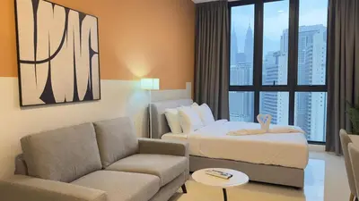 a hotel room with a bed and a couch at Couple suite 291A at KLCC in Kuala Lumpur