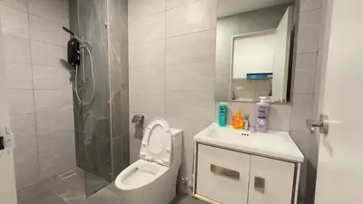 a bathroom with a toilet and a sink and a shower at Couple suite 291A at KLCC in Kuala Lumpur