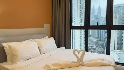a bed with two swans making a heart on it at Couple suite 291A at KLCC in Kuala Lumpur