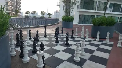 a chess board with chess pieces on a courtyard at Datum Jelatek SKY Ring VIP Nice View in Kuala Lumpur