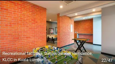 a room with a red brick wall and a table at Datum Jelatek SKY Ring VIP Nice View in Kuala Lumpur