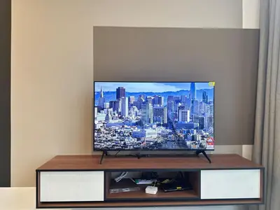 a flat screen tv sitting on top of a table at Private Family suite 23A13A1BR at KLCC in Kuala Lumpur