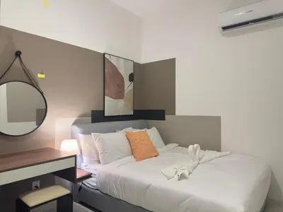 a bedroom with a bed with a desk and a mirror at Private Family suite 23A13A1BR at KLCC in Kuala Lumpur