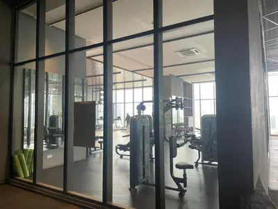 a gym with large glass windows and exercise equipment at COZY Kenwingston The platz Setapak 3BR&2BR 5-8PAX FREE WIFI PARKIN NETFLIX 3306 in Kuala Lumpur