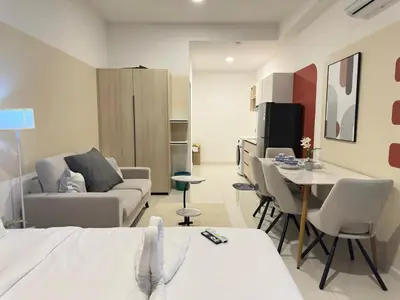 a living room with a bed and a table and chairs at Cozy Couple studio 307B at KLCC in Kuala Lumpur