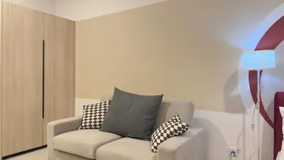 a living room with a couch with pillows on it at Cozy couple suite 272A at KLCC in Kuala Lumpur