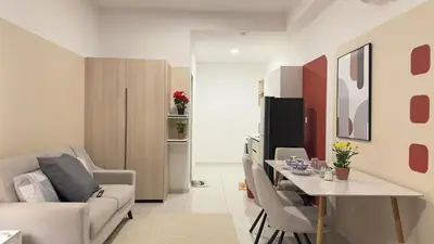 a living room with a couch and a table with chairs at KLCC view couple suite 277B at KLCC in Kuala Lumpur
