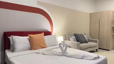 a bedroom with a bed and a couch at KLCC view couple suite 277B at KLCC in Kuala Lumpur