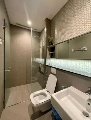 a bathroom with a toilet and a sink and a shower at Lucentia Residence Infinity swimming pool BY Lalaport in Kuala Lumpur