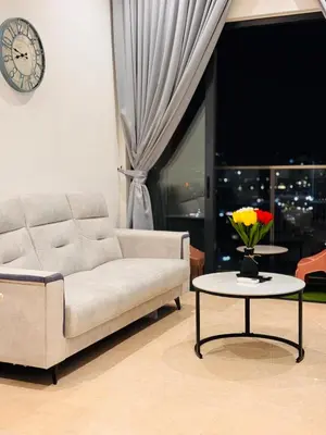 a living room with a couch and a table with flowers on it at Lucentia Residence Infinity swimming pool BY Lalaport in Kuala Lumpur