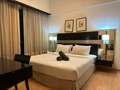 a bedroom with a large bed with a desk and a table at Seri Bukit Ceylon Bukit Bintang Kuala Lumpur City Centre in Kuala Lumpur