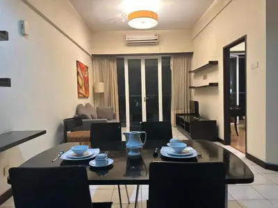 a living room with a table and chairs in a room at Seri Bukit Ceylon Bukit Bintang Kuala Lumpur City Centre in Kuala Lumpur