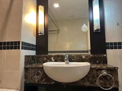 a bathroom with a sink and a mirror at Seri Bukit Ceylon Bukit Bintang Kuala Lumpur City Centre in Kuala Lumpur