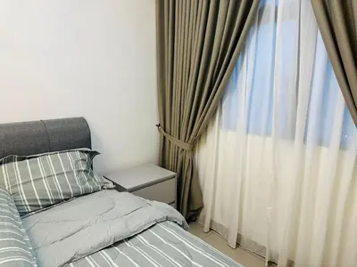 a bedroom with a bed next to a window at Sentul Home Condo-KLCC View with 3bed,3bath, cooking allowed in Kuala Lumpur
