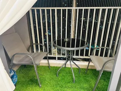 a table and chairs in front of a large window at Sentul Home Condo-KLCC View with 3bed,3bath, cooking allowed in Kuala Lumpur
