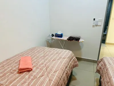 a bedroom with a bed and a table with towels at Sentul Home Condo-KLCC View with 3bed,3bath, cooking allowed in Kuala Lumpur