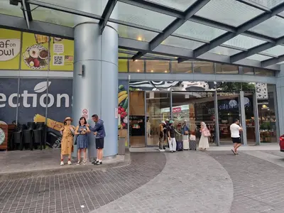 a group of people standing in front of a store at Mercu Summer Suites KLCC By ATIQ in Kuala Lumpur