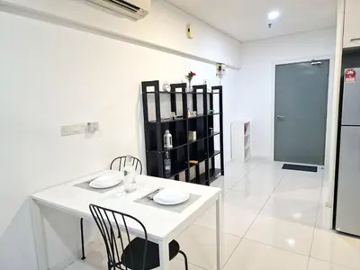 a white dining room with a white table and chairs at Mercu Summer Suites KLCC By ATIQ in Kuala Lumpur