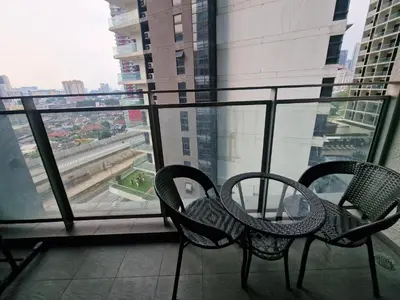 two chairs sitting in front of a window at Mercu Summer Suites KLCC By ATIQ in Kuala Lumpur