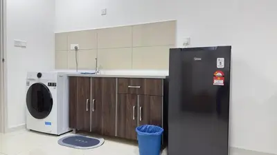 a kitchen with a refrigerator and a washing machine at Cozy couple suite 232B at Majestic Residence in Kuala Lumpur