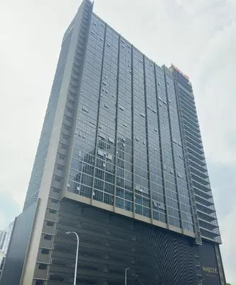 a tall glass building with a lot of windows at Cozy couple suite 232B at Majestic Residence in Kuala Lumpur