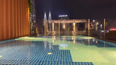 a swimming pool on top of a building at night at Luxury copule suite 232A at KLCC in Kuala Lumpur