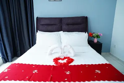 a bed with two hearts and flowers on it at Bukit Bintang Robertson Residences, KLCC in Kuala Lumpur