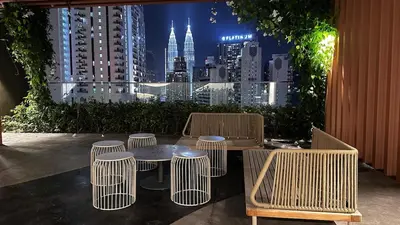a table and chairs with a view of a city at Luxury studio suite 277A at KLCC in Kuala Lumpur