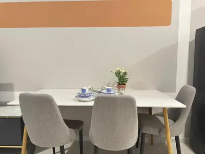 a dining room table with two chairs and a white table at Luxury studio suite 277A at KLCC in Kuala Lumpur