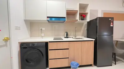 a kitchen with a refrigerator and a washing machine at KLCC view couple stay 276A at KLCC in Kuala Lumpur