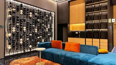a blue couch with orange pillows in a room at Luxury private family suite 26161BR at KLCC in Kuala Lumpur