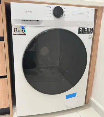 a white washing machine with a black window at KLCC view studio suite 272B at KLCC in Kuala Lumpur
