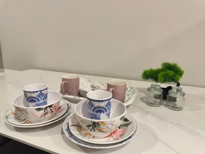 a table with four tea cups and saucers on it at Luxury couple suite 295A at KLCC in Kuala Lumpur