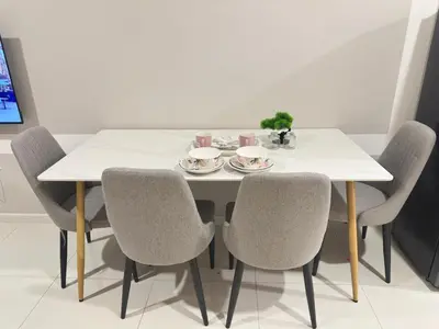 a dining room table with chairs and a white table at Luxury couple suite 295A at KLCC in Kuala Lumpur