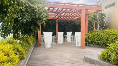 a pavilion with tables and chairs in a garden at KLCC view couple suite 293B at KLCC in Kuala Lumpur