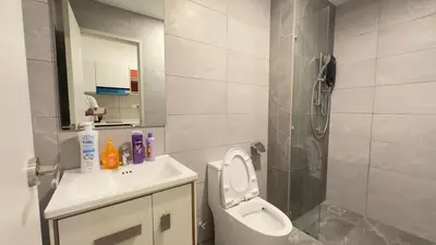 a bathroom with a toilet and a sink and a shower at KLCC view couple suite 293B at KLCC in Kuala Lumpur