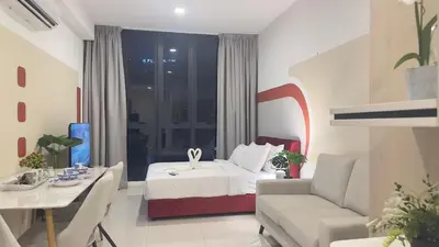 a bedroom with a bed and a couch and a table at KLCC view couple suite 293B at KLCC in Kuala Lumpur