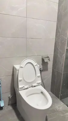 a bathroom with a toilet with the lid up at Cozy KLCC view suite 305B at KLCC in Kuala Lumpur