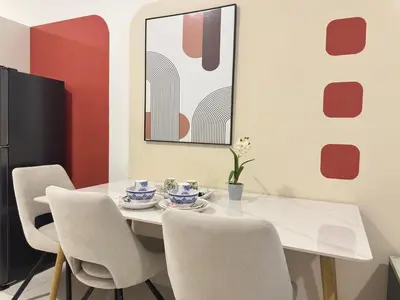 a dining room with a white table and chairs at Cozy KLCC view suite 305B at KLCC in Kuala Lumpur