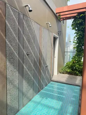 a swimming pool with blue tiles on the side of a building at KLCC view cozy suite 251A at KLCC in Kuala Lumpur