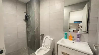 a bathroom with a shower and a toilet and a sink at KLCC view cozy suite 251A at KLCC in Kuala Lumpur