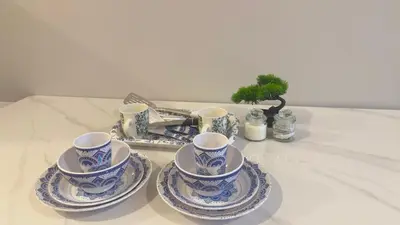 a group of blue and white cups and saucers on a table at KLCC view couple suite 292A at Majestic residence in Kuala Lumpur